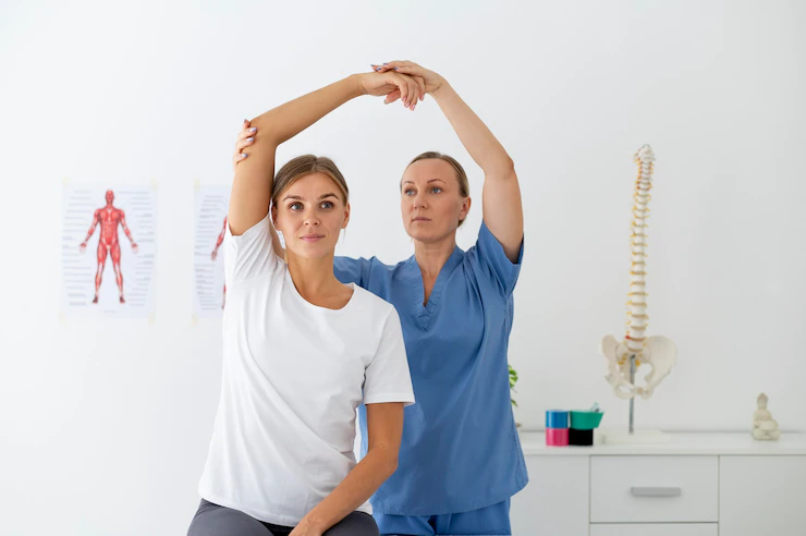physiotherapist-helping-female-patient-her-clinic