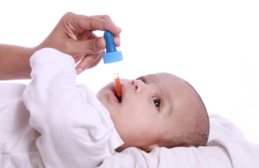 Baby taking vitamin medicine