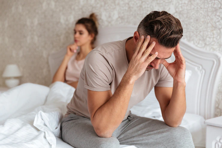 sad-man-sitting-bed-with-his-girlfriend